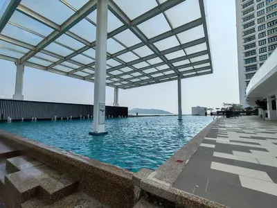 a large swimming pool with a roof over it at Invincible Seaview Vacation Condo 3R3B 8Pax in Bayan Lepas