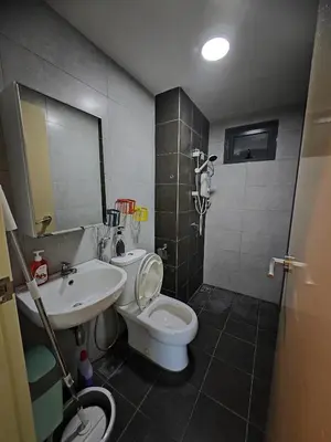 a bathroom with a white toilet and a sink at Modern Comfy Suite Room-9Pax in Perai
