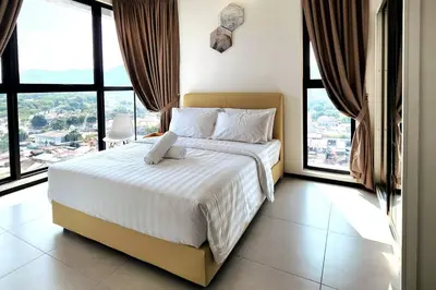 a bedroom with a large bed with large windows at Urban Muji Retreat Suites #3BR #2carparks in Jelutong