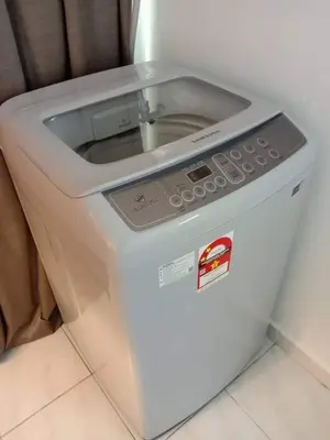 a washing machine sitting on the floor in a room at HOMESTAY ANGGUN SAFIYYA in Bayan Lepas