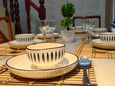 a table with a plate and a bowl and a spoon at 【Ipoh Garden】4Br/8pax All Attractions w/in 15mins in Ipoh