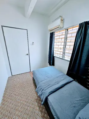 a small bedroom with a bed and a window at PANCHOR 6 HOSTEL in George Town