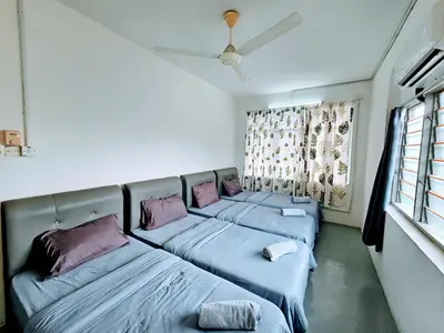 a room with three beds with pillows and a window at PANCHOR 6 HOSTEL in George Town
