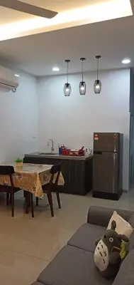 a living room with a couch and a table and a kitchen at Pantai Remis Homestay 118A in Pantai Remis