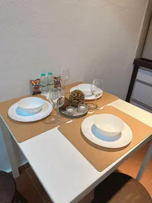 a table with plates and wine glasses on it at The Family Suit in George Town