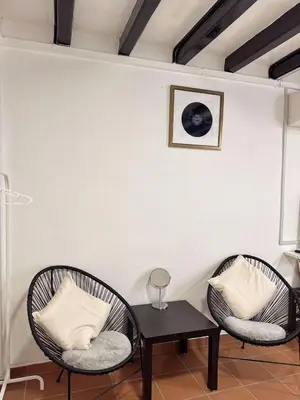 two wicker chairs and a table in a room at The Family Suit in George Town