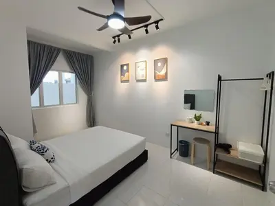 a white bedroom with a bed and a desk at Dream 5 @ Emerald avenue in Brinchang