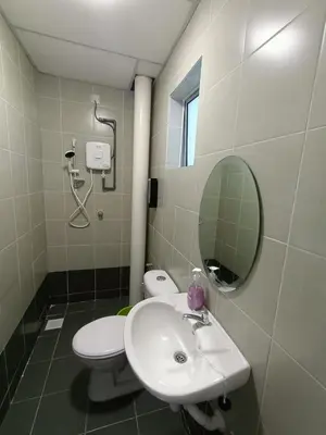 a bathroom with a sink and a toilet and a mirror at Dream 5 @ Emerald avenue in Brinchang