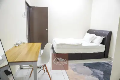 a small room with a bed and a table at HAZZ Homestay Kulim in Kulim