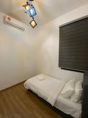 a bedroom with a bed with white sheets and a window at Modern Lux Suite, The Cove Hillside Residence in Ipoh