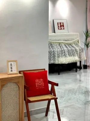 a red pillow sitting on a chair in a room at Cozy 2StoreyHome 5Room11Pax@ChaiLengPark in Perai