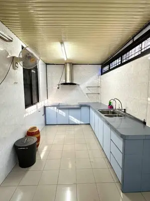 a large kitchen with blue cabinets and a sink at Cozy 2StoreyHome 5Room11Pax@ChaiLengPark in Perai