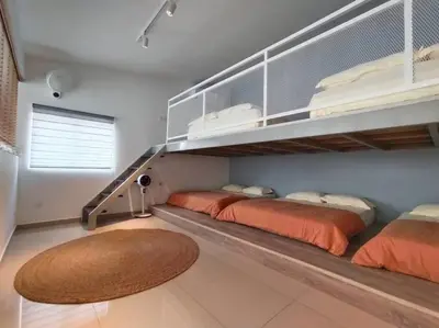 a bedroom with two beds and a staircase at Evening/Night de Ville-50pax Private Pool BBQ in Ipoh