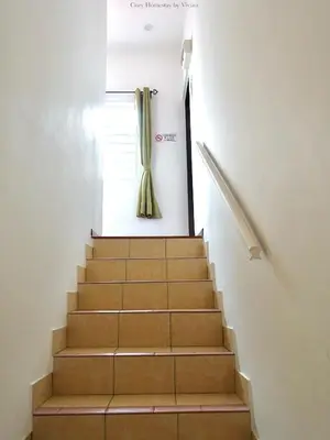 a set of stairs with a curtain on the window at Ipoh Cozy Homestay for 10-13pax in Ipoh