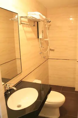 a bathroom with a sink and a toilet at AG Hotel Penang in George Town