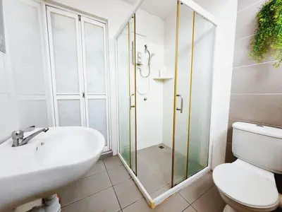 a bathroom with a shower and a toilet and a sink at 38 Georgetown 3 Storey Terrace local food 5rooms 16pax in George Town