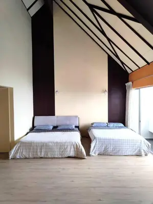 two beds in a large room with at Silverpart Resort Fraser Hill C3-6-1 Forest View High Floor No lift in Bukit Fraser