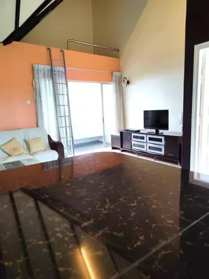 a living room with a couch and a flat screen tv at Silverpart Resort Fraser Hill C3-6-1 Forest View High Floor No lift in Bukit Fraser