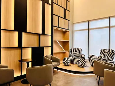a room with chairs and a table and a window at Prime Comfort Seaview with Netflix and Water Filter near Georgetown in Jelutong