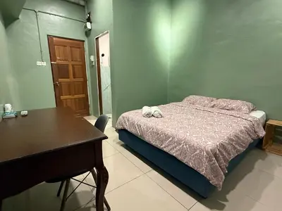 a bedroom with a bed and a table and a desk at 85 Boutique Hotel in Ipoh