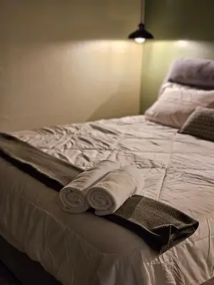 a bed with towels and pillows on it at 85 Boutique Hotel in Ipoh