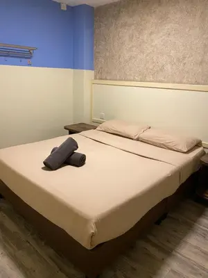 a bedroom with a bed with a hat on it at Suria Cameron Hotel in Tanah Rata