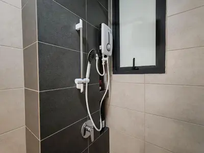 a shower in a bathroom with a mirror at Cityscape Suite, 4 to 5 Pax at Urban Suites Georgetown by SuperStay in Jelutong