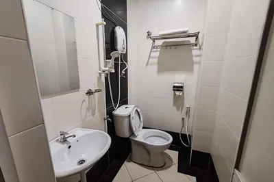 a small bathroom with a toilet and a sink at Hotel Kuang Hua Sitiawan Near To UniKL-MIMET in Sitiawan