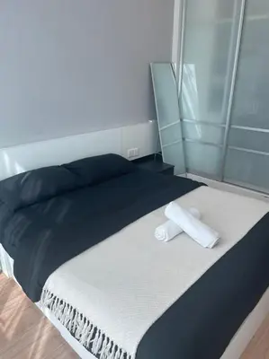 a bed with a towel on top of it at Georgetown ins cozy 2 bedroom in George Town