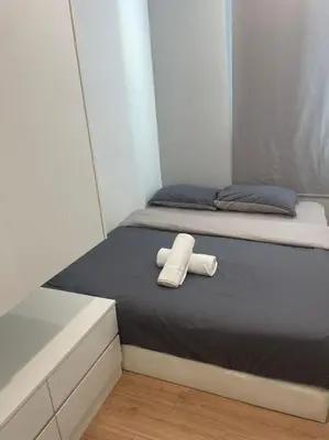 a bed with a white towel on top of it at Georgetown ins cozy 2 bedroom in George Town