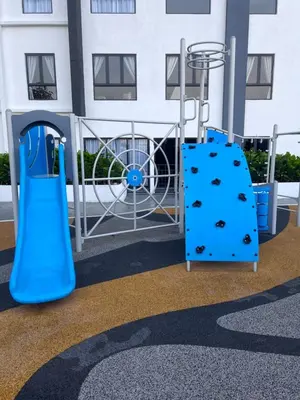 a playground with a blue slide in front of a building at The Horizon Ipoh Blissful Homestay 2 in Ipoh