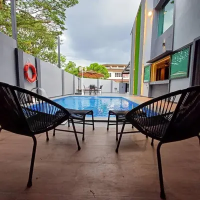 a group of chairs sitting next to a swimming pool at LYL Jaccuzi Private Pool House - 16PAX in Ipoh