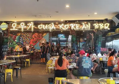 a group of people sitting at tables in a restaurant at Maritime Seaview Comfy Suite Penang with TVbox,Pool,Freewifi,2-8pax in Jelutong