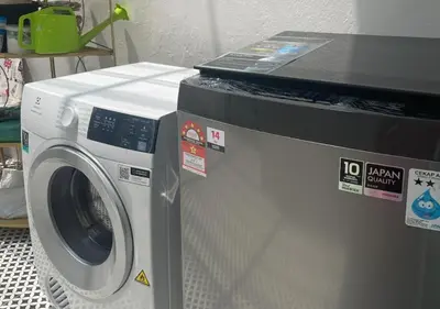 a washing machine with stickers on top of it at Modern Victorian Homestay in Jelutong