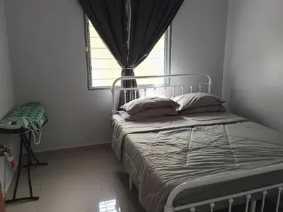 a bed in a room with a window and a bed sidx sidx sidx at Sal Homestay in Slim River