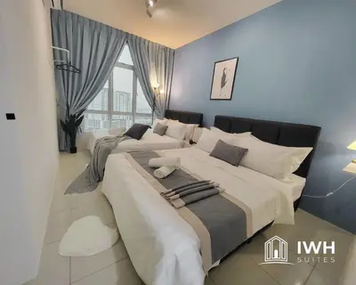 two beds in a bedroom with blue walls at Ipoh Anderson Town Suites with 2 Parking by IWH in Ipoh