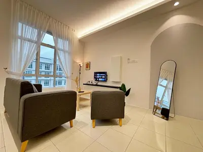 a living room with two chairs and a mirror at Ipoh Anderson Town Suites with 2 Parking by IWH in Ipoh