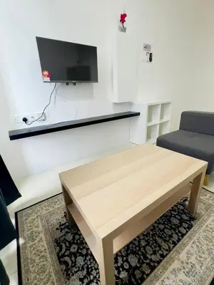 a living room with a coffee table and a tv at Ipoh Anderson Suites by Migliore in Ipoh