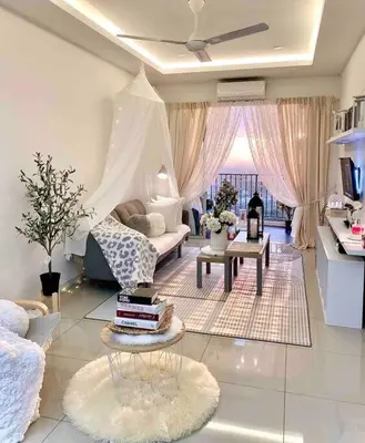 a living room with a couch and a table with books at Blubelle Apt Near Lake Garden Zoo With Wifi Netflix in Taiping
