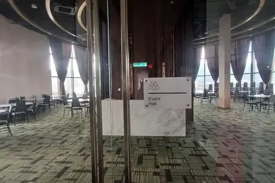 a room with tables and chairs and a sign on a wall at Aesthetic Urban Suite With Infinite Pool & Gym in Jelutong
