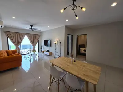 a living room with a wooden table and chairs at Manhattan Condominium - Jalan Pasir Puteh - Ipoh in Ipoh