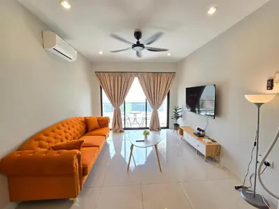 an orange couch in a living room with a ceiling fan at Manhattan Condominium - Jalan Pasir Puteh - Ipoh in Ipoh