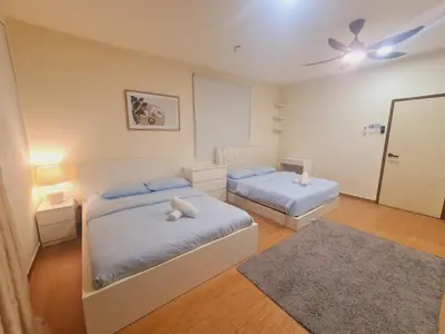 a bedroom with two beds and a ceiling fan at UniVilla- Ideal Family Home for 18pax in Gelugor