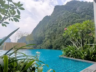 a swimming pool with a mountain in the background at Lost World of Tambun, Sunway Onsen Studio, 1BR, 2-4pax in Tambun