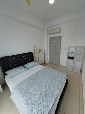a bedroom with a large bed with a blue blanket at OV06-3room Georgetown Seaview Pg in George Town