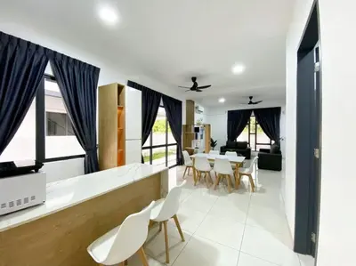 a kitchen and dining room with a table and chairs at BrandNew Modern Cozy House@ALMA NEAR JUSCO in Bukit Mertajam