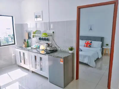 a kitchen with a table and a bed in a room at Georgetown, Up to 5 Pax, 2 Bedrooms, 1 Bathroom, 1 Car Park by Star Home in George Town