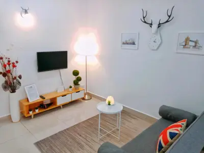 a living room with a couch and a table and a tv at Georgetown, Up to 5 Pax, 2 Bedrooms, 1 Bathroom, 1 Car Park by Star Home in George Town