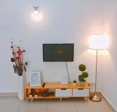 a living room with a tv on a white wall at Georgetown, Up to 5 Pax, 2 Bedrooms, 1 Bathroom, 1 Car Park by Star Home in George Town