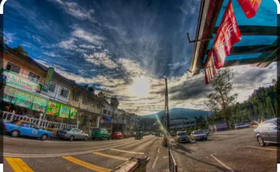 a city street with cars parked on the street at Hillside cottage chalet studio in Tanah Rata